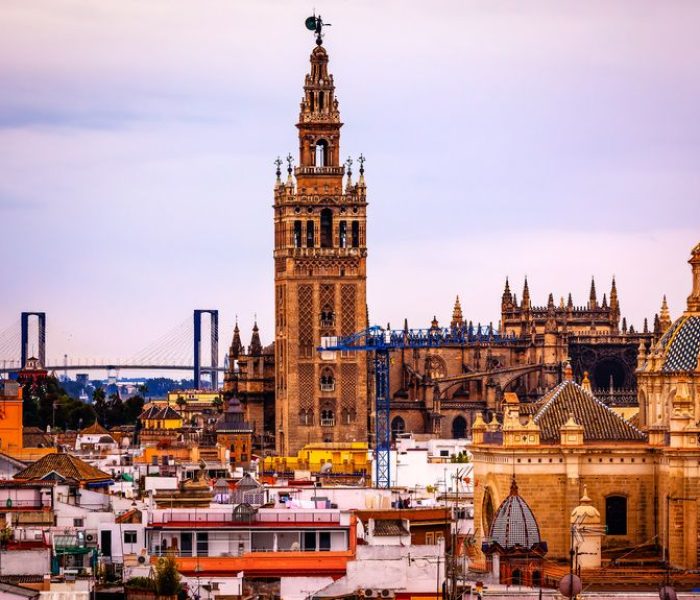 Giralda Spire Bell Tower Seville Cathedra, Cathedral of Saint Mary of the See Church of El Salvador Seville, Andalusia Spain. Giralda is largest Gothic Cathedral in the World and burial Place of Christopher Columbus.